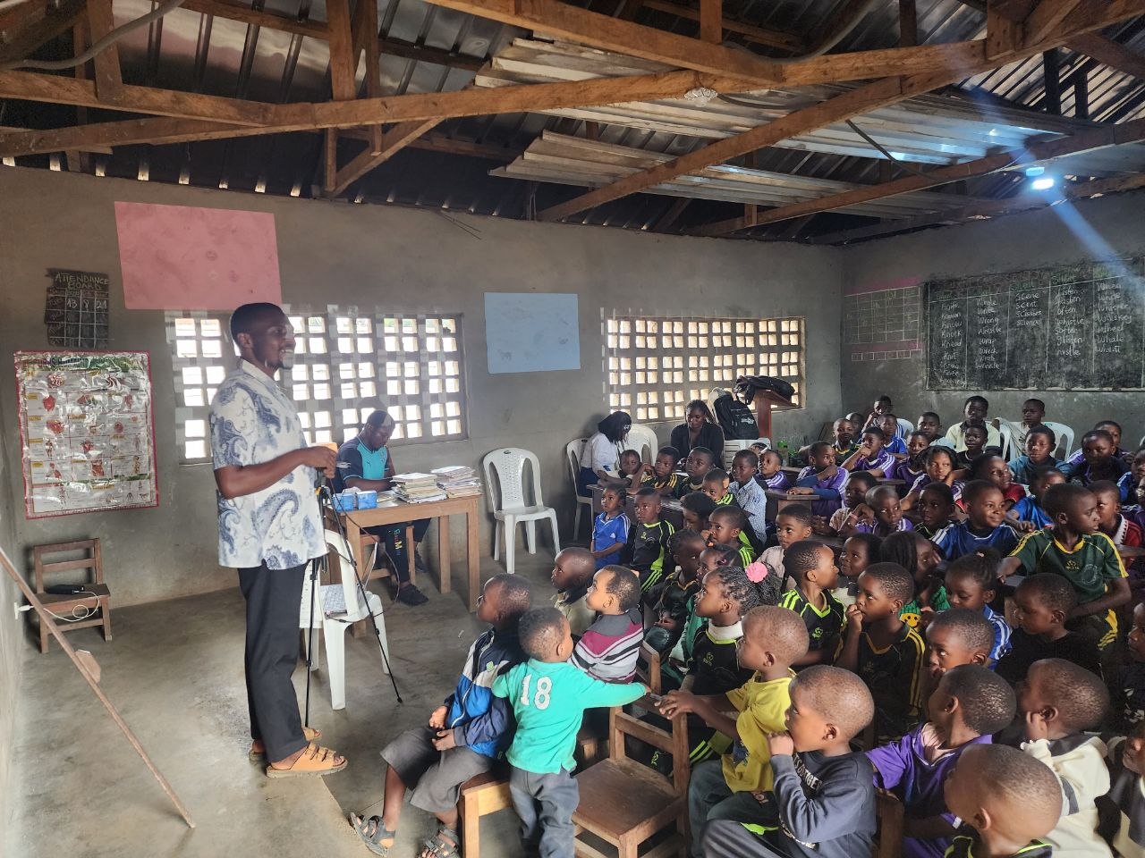 An educator addressing pupils during a classroom learning session.